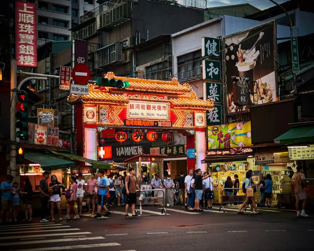 Entrance to Raohe Street Night Market in Songshan, Taipei, illuminated at night