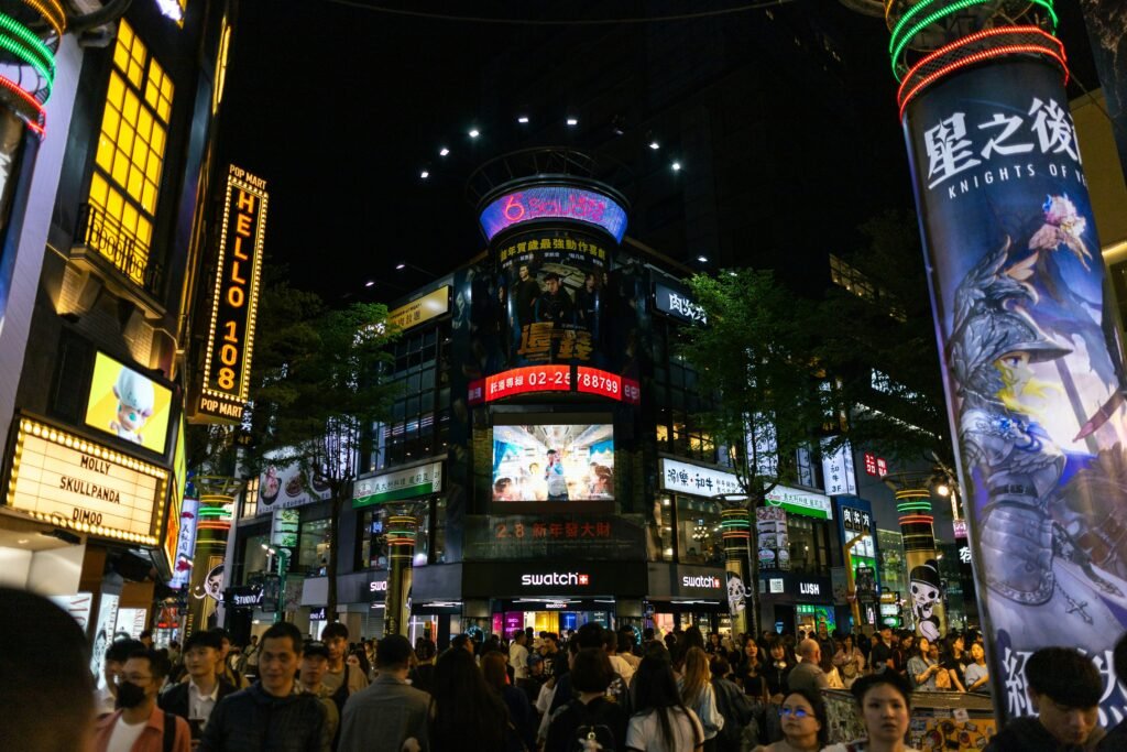 Crowds, shops and illuminated signs in Ximending at night in Taipei